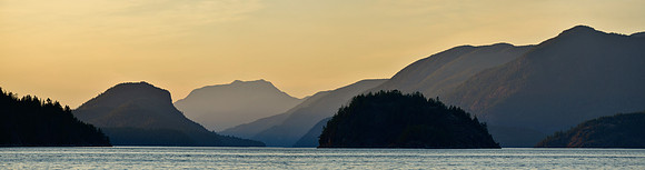 Looking north from Feather Cove before sunrise. The dome-shaped island is Station Island, Kinghorn Island is in the foreground to its left and West Redonda Island is behind it.