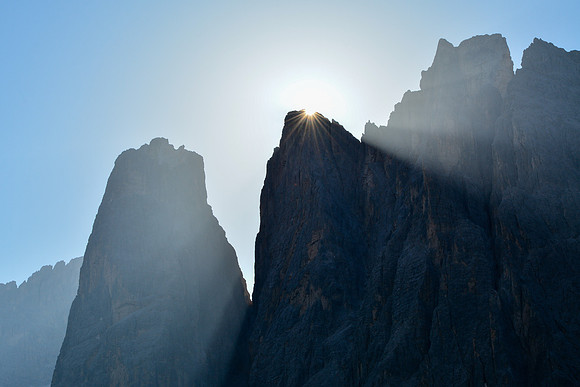 The sun rises behind Crode Fiscaline, with Cima Una on the left