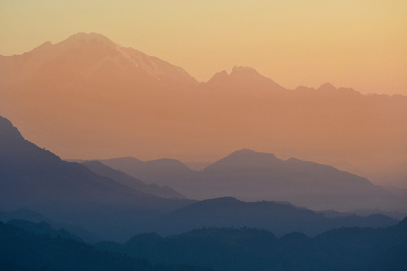 A hazy sunrise above Pokhara from the ridge south of Phewa Lake