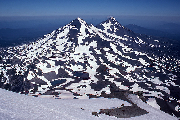 The Middle Sister and North Sister from the summit of the South Sister; Mount Hood in the far distance