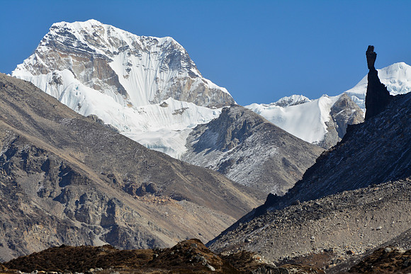 A rock spire at the base of Gimmigela, with Pathibara in the distance