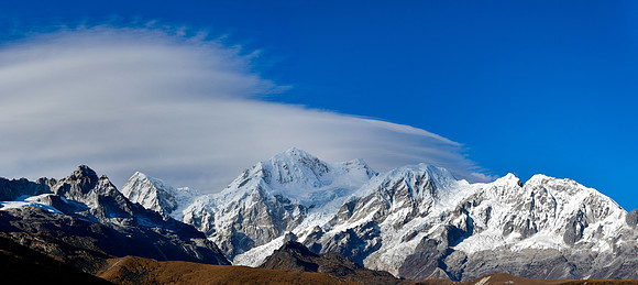 Lenticular clouds over Rathong, Kabru, Karbru Dome and Forked Peak, with an unnamed rocky peak on the left, from the ridge northeast of Panding
