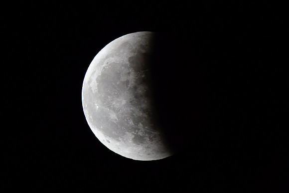The moon leaving the earth's shadow
