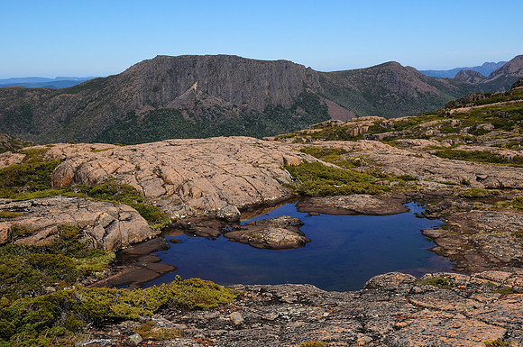 A small tarn on the ridge north of Lake Selene, with Walled Mountain and Mac's Mountain in the distance, Cradle Mountain-Lake St. Clair National Park