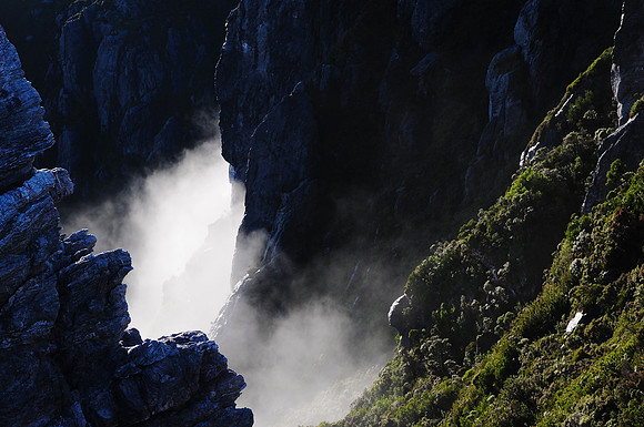 The mist rises through the crags between Lake Cygnus and Mount Hayes, Western Arthur Range, Southwest National Park
