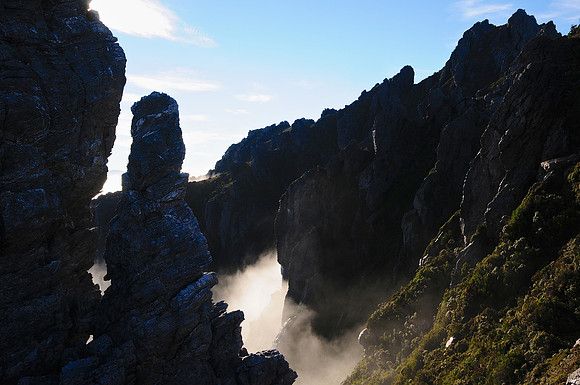 The mist rises through the crags between Lake Cygnus and Mount Hayes, Western Arthur Range, Southwest National Park